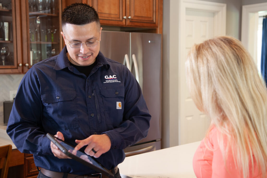 GAC technician going over maintenance plans with customer